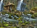 waterfall by a cabin mill