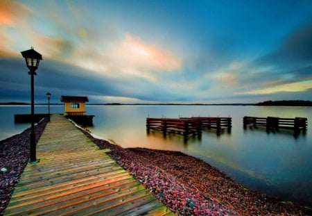 Cloudy afternoon - blurred, light, reflection, dark, shore, mirror, lake, cloudy, sky, clouds, water, sea, stones, pier, river, nature, peaceful