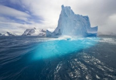 Frozen Iceberg - clouds, water, blue, light, reflection, iceberg, ice, frozen, white, nature, cold, lake, day, sky, solid