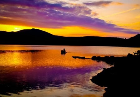 Sunset Lake - person, purple, water, boat, yellow, lake, sky, land, orange, sunset, nature, mountain, day, cclouds