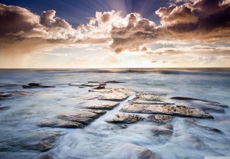 Flat Smooth Rock - rock, water, beach, ocean, tan, shore, white, sky, clouds, gold, nature, tide, day, flat