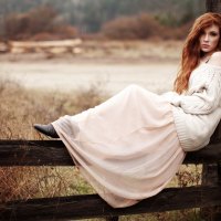 Girl sitting on fence