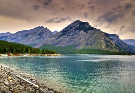 Beautiful Lake Minewanka - forest, evergreen, water, stones, daylight, blue, lake, sky, clouds, trees, nature, mountain, day