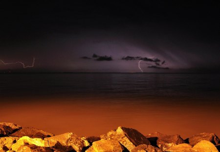 Storm Coming Night - nice, beauty, rays, seaside, beach, sky, night, black, beije, storm, amazing, cool, clouds, beautiful, awesome, stones