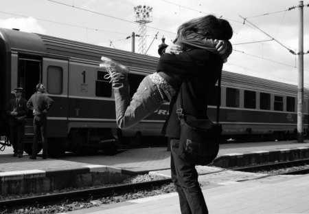 young couple at the train station - conductor, train, couple, station