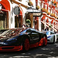 row of supercars in front of hotel