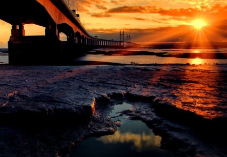 Sun rays over the sea - sky, sun, water, shine, sun rays, reflection, clouds, orange, golden, afternoon, bridge, ocean, sunlight, light, waves, nature, glow, beautiful, sea