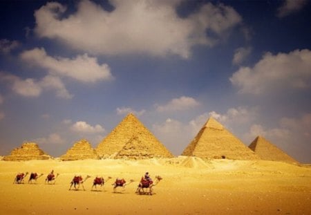 Caravan - bedouins, camels, desert sand, pyramids