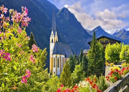 Mountain clock tower - summer, street, beautiful, village, light, castle, nature, mountain, flowers, cloudsr, clock tower, sky, town, peaks, houses, slopes, high, towe