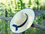 Straw Hat Hanging on Fence