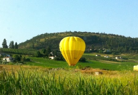 A Yellow Hot Air Balloon - hills, yellow, transportation, road scene, field, grass, balloon