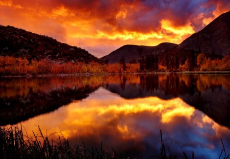 Lake in fire - nice, lakeshore, sky, sundown, trees, riverbank, water, lakescape, sunset, mirrored, fire, reflection, river, clouds, orange, lake, mountain, light, shore, lovely, nature, glow, fiery, red, beautiful