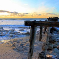 old pier on beach in winter