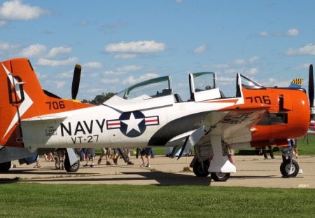 Aircraft VT-27 is a Primary training squadron USA - black, grass, blue, white, sky, airplane, clouds, military, aircraft, orange, wheels, star, green