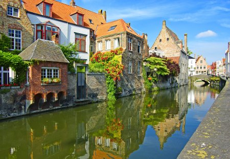 River town - calm, summer, town, stream, reflection, flowers, shore, riverbank, nice, houses, sky, clouds, beautiful, lovely, river, peaceful, bridge