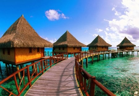 Tropical bungalows - nice, sky, tropics, water, bungalows, wind, vacation, reflection, emerald, clouds, holiday, green, sunny, relax, rays, maldives, ocean, bahamas, tropical, huts, lovely, caribbean, nature, glow, pier, beautiful, rest, sea