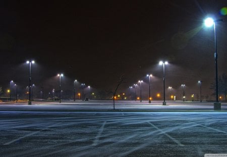 where chilly winds blow - light poles, wind, snow, night, parking lot