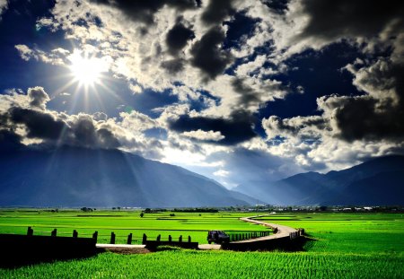 Splendor - amazing, splendor, landscape, grass, sunrays, car, view, field, sky, sun, clouds, sunlight, trees, beautiful, sunbeams, road, beauty, lovely, tree, village, nature, rays, green, mountains, peaceful