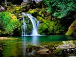 waterfall over green stones