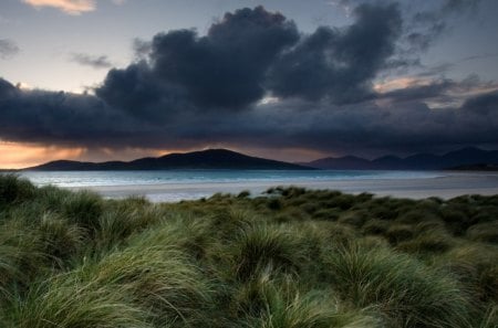 stormy shore landscape - clouds, beach, sea, mountain, grass