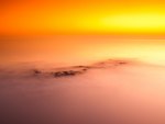 fiery sunset on an misty italian beach