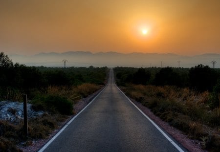 long straight road in santa pola spain - mountains, bushes, road, sunset