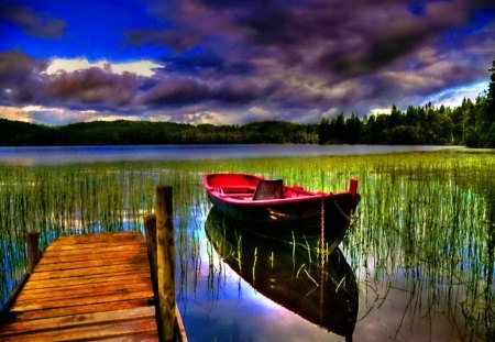 Boat in the river - nice, sky, riverbank, colorful, clear, mirrored, reflection, evening, calmness, river, clouds, afternoon, dusk, grass, summer, lovely, nature, bright, pier, red, beautiful, island, waters, canoe