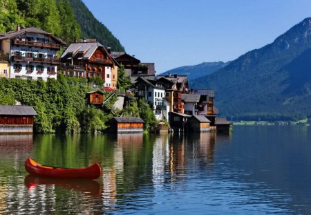 Village on the riverbank - nice, sky, riverbank, greenery, colorful, clear, mirrored, cottages, crystal, reflection, clouds, river, boat, houses, lake, mountain, summer, shore, cabins, lovely, nature, bright, village, town, beautiful, flowers