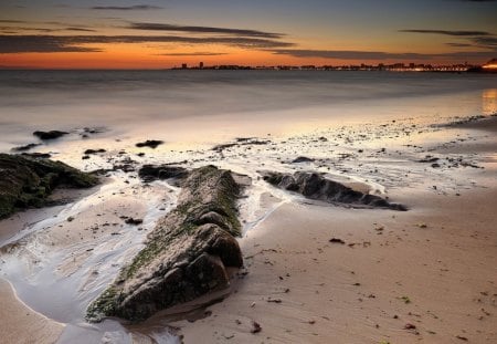 Beautiful Sunset - beautiful, beach, ocean, architecture, seascape, view, light, city, ocean waves, nature, sunset, city lights, beauty, buildings, peaceful, sky, sand, building, reflection, sunlight, clouds, lovely, splendor, sea, colors, waves