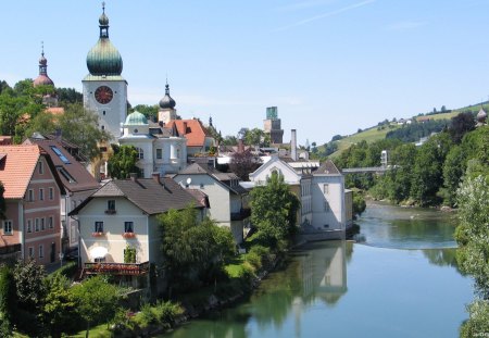 a river in a town full of churches in austria - town, trees, churches, river