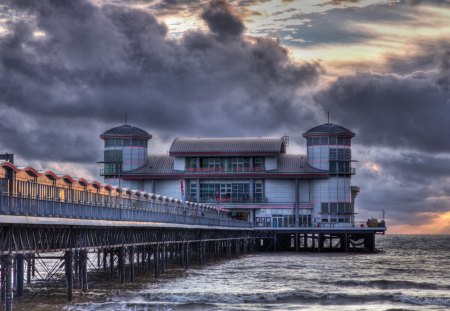 Sunset - beauty, sky, ocean waves, peaceful, sunset, storm, view, clouds, sunrays, stormy, bridge, ocean, sunlight, seascape, lovely, waves, nature, pier, beautiful, splendor, sea