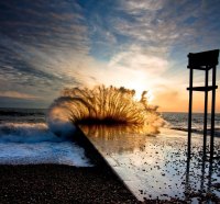 crashing waves on cement barrier