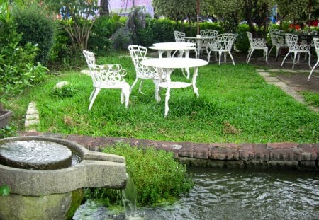 Casual area - stone mill, table and chair, grasses, casual area