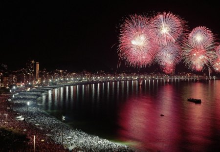 fireworks over crowded city beach - city, beach, crowd, fireworks