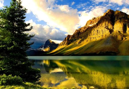 Magic mountain - lakeshore, nice, sky, magic, riverbank, shine, amazing, reflection, river, clouds, sunny, tree, golden, rays, lake, sunlight, mountain, shore, lovely, nature, glow, beautiful