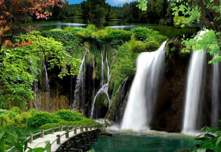 Garden waterfall - nice, sky, greenery, water, colorful, waterfall, calm, fall, emerald, green, tree, garden, bridge, grass, branches, falling, park, summer, lovely, serenity, bushes, nature, tranquility, beautiful