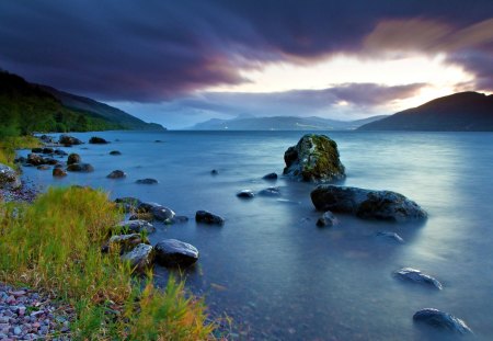 Beautiful View - beauty, sky, peaceful, water, sunset, mountains, storm, rocks, view, clouds, green, stormy, grass, lake, landscape, lovely, nature, beautiful, splendor, colors