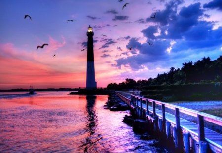 Lighthouse at sunset - nice, sky, sundown, riverbank, water, colorful, sunset, purple, reflection, clouds, river, afternoon, dusk, ocean, lighthouse, summer, shore, lovely, nature, pier, romantic, beautiful, twilight, colors, sea