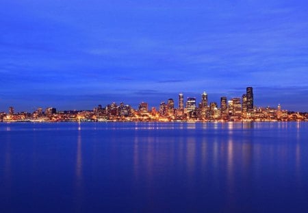 City Lights - blue, skyline, splendor, blue sky, city lights, reflection, view, skyscrapers, lake, sky, clouds, water, beautiful, sea, city, beauty, lovely, architecture, ocean, buildings, nature, lights, peaceful, building