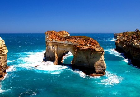 island archway in blue green sea - arch, island, sea, rocks