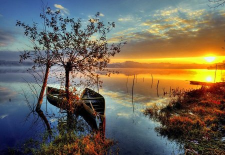 Lake at sunrise - summer, sundown, grass, sunrise, light, shore, lake, nice, sky, clouds, sunlight, trees, beautiful, mirrored, refelction, lovely, boats, glow, nature, sunset, rays