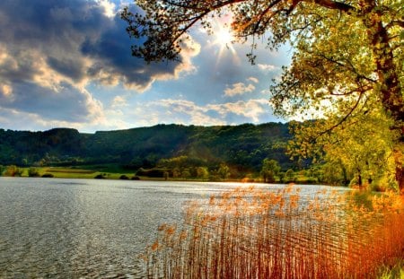 Peaceful Place - beauty, autumn, sky, trees, sun, peaceful, water, mountains, autumn leaves, view, clouds, sunny, sunrays, tree, hill, lake, sunlight, hills, landscape, autumn splendor, lovely, nature, autumn colors, beautiful, leaves, splendor