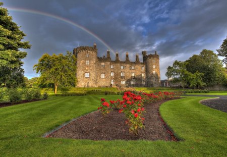 After The Rain - red roses, rainbow, rain, bench, house, red rose, architecture, fence, nature, green, building, mansion, splendor, landscape, neauty, benches, grass, ireland, medieval, view, houses, sky, castle, clouds, trees, beautiful, windows, lovely, kilkenny castle, tree, stairs, rose, peaceful