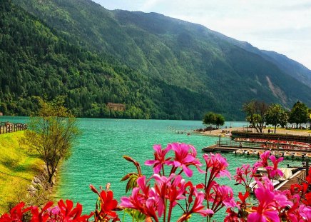 Lake pier - nice, lakeshore, people, peaceful, riverbank, greenery, colorful, clear, mist, crystal, emerald, river, green, cliffs, lake, boats, mountain, summer, shore, lovely, slopes, serenity, nature, pier, beautiful, waters, flowers