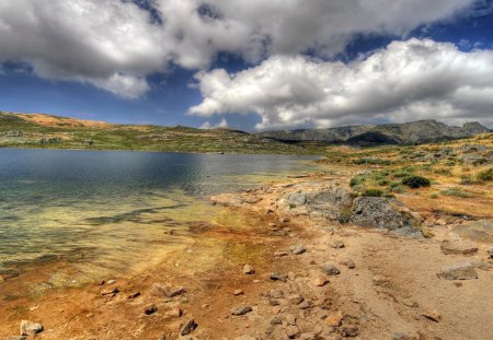 water's edge - sand, mountains, bblue sky, rocks, water, clouds