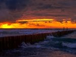 wooden sea breaker at sunset