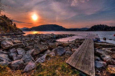 Sunset pier - pretty, hills, summer, sundown, amazing, sunrise, light, shore, nice, sky, sun, clouds, water, beautiful, sea, lovely, ocean, dock, stones, pier, glow, colorful, river, nature, sunset, rays, waves, rocks, shine, bank