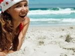 Happy Santa girl on the beach