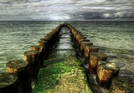 As Far As You Can See - storm, clouds, water, blue, poles, grass, browm, ocean, nature, green, land, day, sky