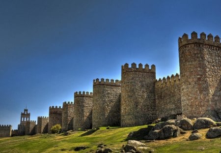 fortress in avila spain - towers, grass, rocks, wall, fort